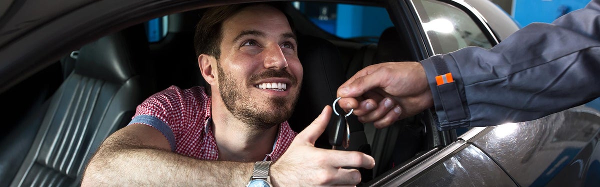 Satisfied Male Customer receiving car keys | All Star Pre-Owned Supercenter in Baton Rouge LA